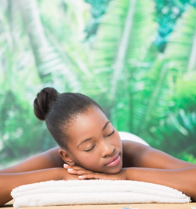 Pretty woman lying on massage table at the health spa